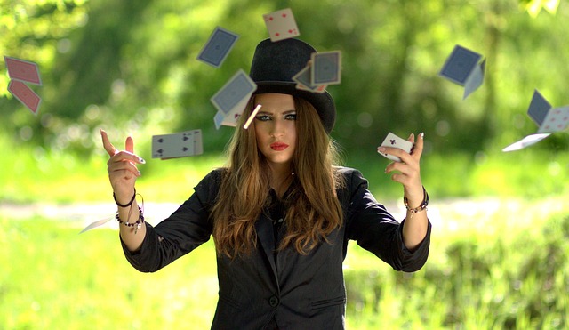 A magician surrounded by floating playing cards.